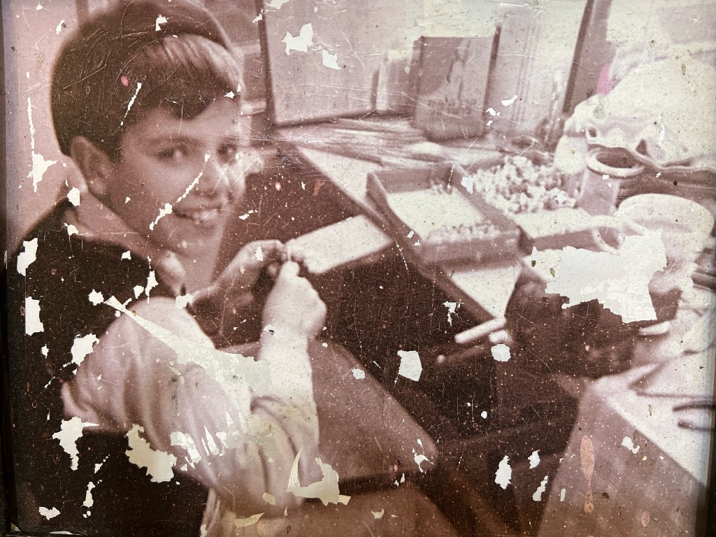 A young Sol at the workbench, sizing a ring